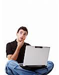 Young man using a laptop, with thoughtful expression. Isolated on white background.