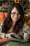 Beautiful Latina Woman at table in Kitchen with Coffee or Tea