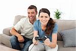 Portrait of a woman playing video game with her boyfriend in the living room