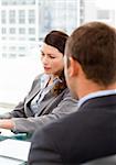 Rear view of a businessman during an interview with a female manager in her office