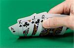 player's hand with the cards on the green game table