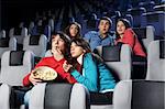 Group of young men look a terrible film at a cinema