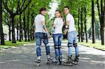 Three young scooters stand having turned back in park