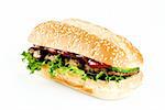 Ribeye steak in sesame seed bun isolated over white background