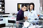 The girl-seller shows to the visitor assortment in jeweller shop