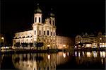 Ancient christian cathedral in Luzerne, Switzerland at night. View from a bridge