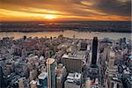 New York City Manhattan sunset skyline aerial view with office building skyscrapers and Hudson River.