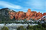 Red rocks in Bryce Canyon National Park with snow and trees in Utah.