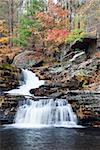 Waterfall with trees and rocks in mountain in Autumn. From Pennsylvania Dingmans Falls.