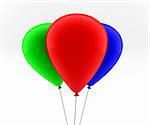 three colored balloons fly in the air