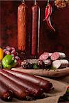 A composition of different sorts of sausages on dark background