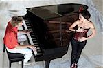 Handsome young man playing on the piano