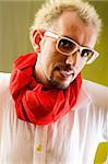 Man with red scarf against coloured background