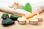 towel and zen stones showing a bath or wellness concept