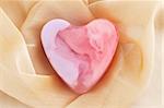 Pink soap in the form of the heart  on the cloth