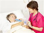 Nurse helps senior patient do breathing exercises in the hospital.