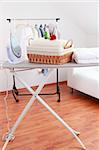 Basket with laundry and ironing board