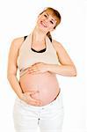 Happy beautiful pregnant woman touching her belly isolated on white background