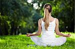 A girl in one of the yoga postures back outdoors