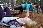 Women exercising together in forest