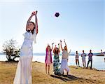 Bride throwing bouquet to friends