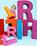 Toddler playing with oversize letters