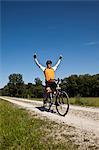 Biker cheering on dirt road