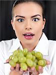 Portrait of beautiful woman she holding green grapes