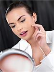 Portrait of beautiful woman, she looking at mirror