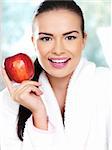Portrait of beautiful woman, she holding red apple