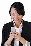 Attractive happy business woman reading SMS on cellphone against white.