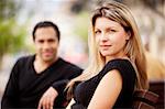 A french couple sitting on a city park bench