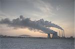 Coal powerplant - sun, chimneys and fumes