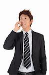 Young entrepreneur talking on phone with smiling expression over white background.