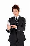 Business man using cellphone to type message.