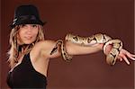 cute blond woman holding a Royal Python snake
