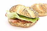 Sandwich made of bun with ham and lettuce on white background