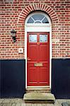 Period front door in a brick facade