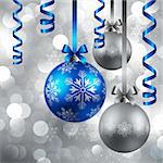 christmas blue and silver baubles on shining silver background