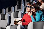 The couple with pop-corn looks cinema in 3d