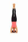 Young woman doing yoga Headstand Pose