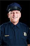 Portrait of friendly, smiling police officer on black background.