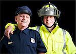 Portrait of happy, smiling police officer and fire fighter on black background.