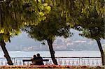 Young couple looking out over Lake Como from Ballagio, Italy