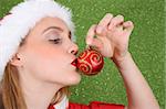 Christmas girl kissing a red and gold decoration