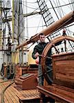 young man at the helm sailing ship