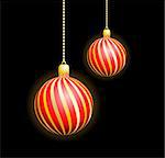 Two Christmas red spheres in a gold strip on a black background