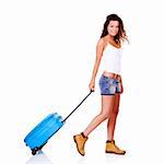 Beautiful young woman walking with a blue suitcase, isolated on white background