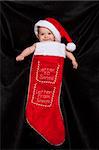 A young child inside a christmas stocking