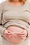 Good pregnant woman breaking a cigarette standing in the living room